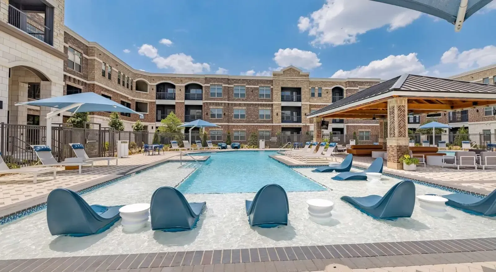 Resort-style community pool with lounge seating