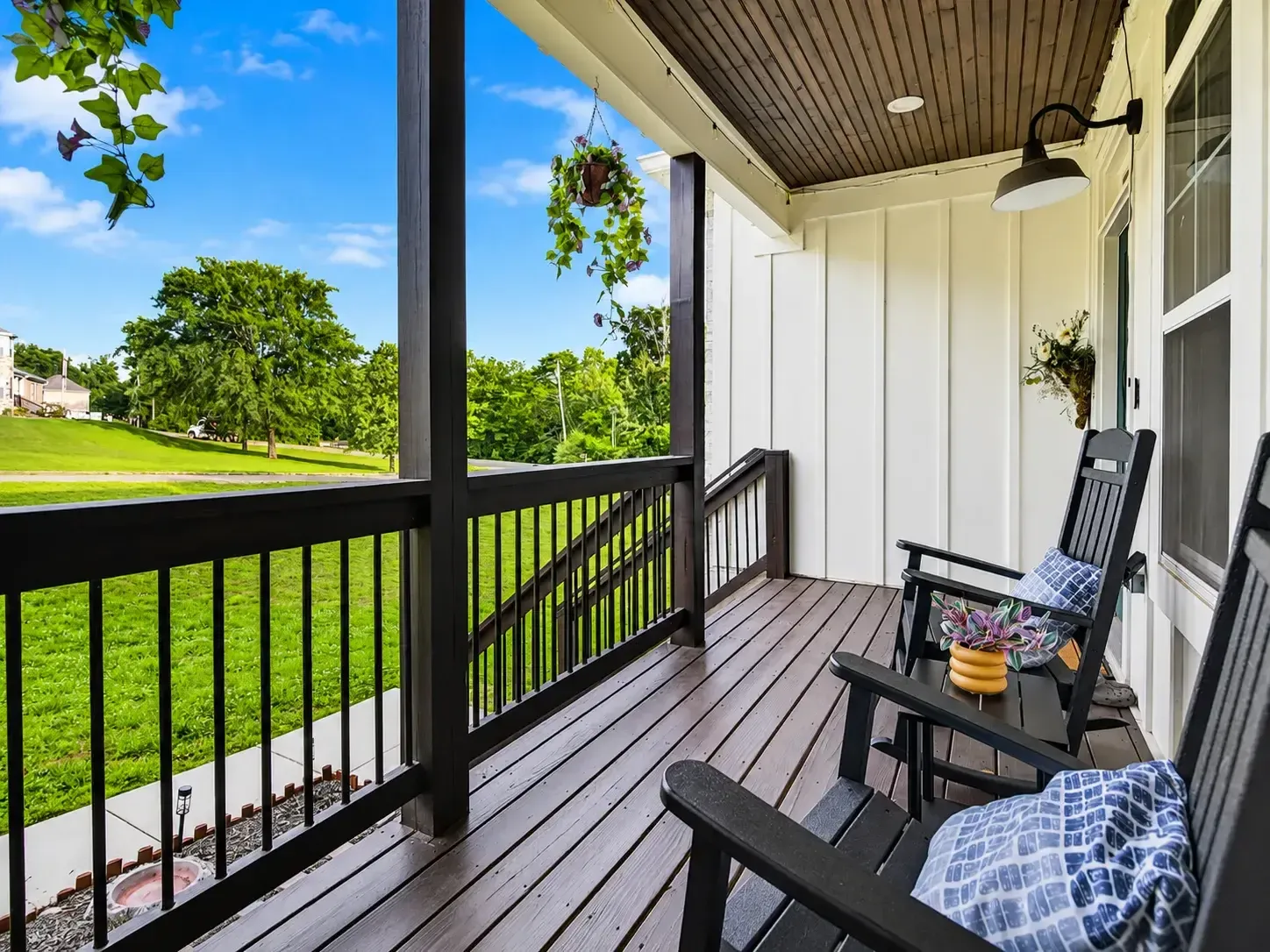 Covered back porch overlooking a green lawn