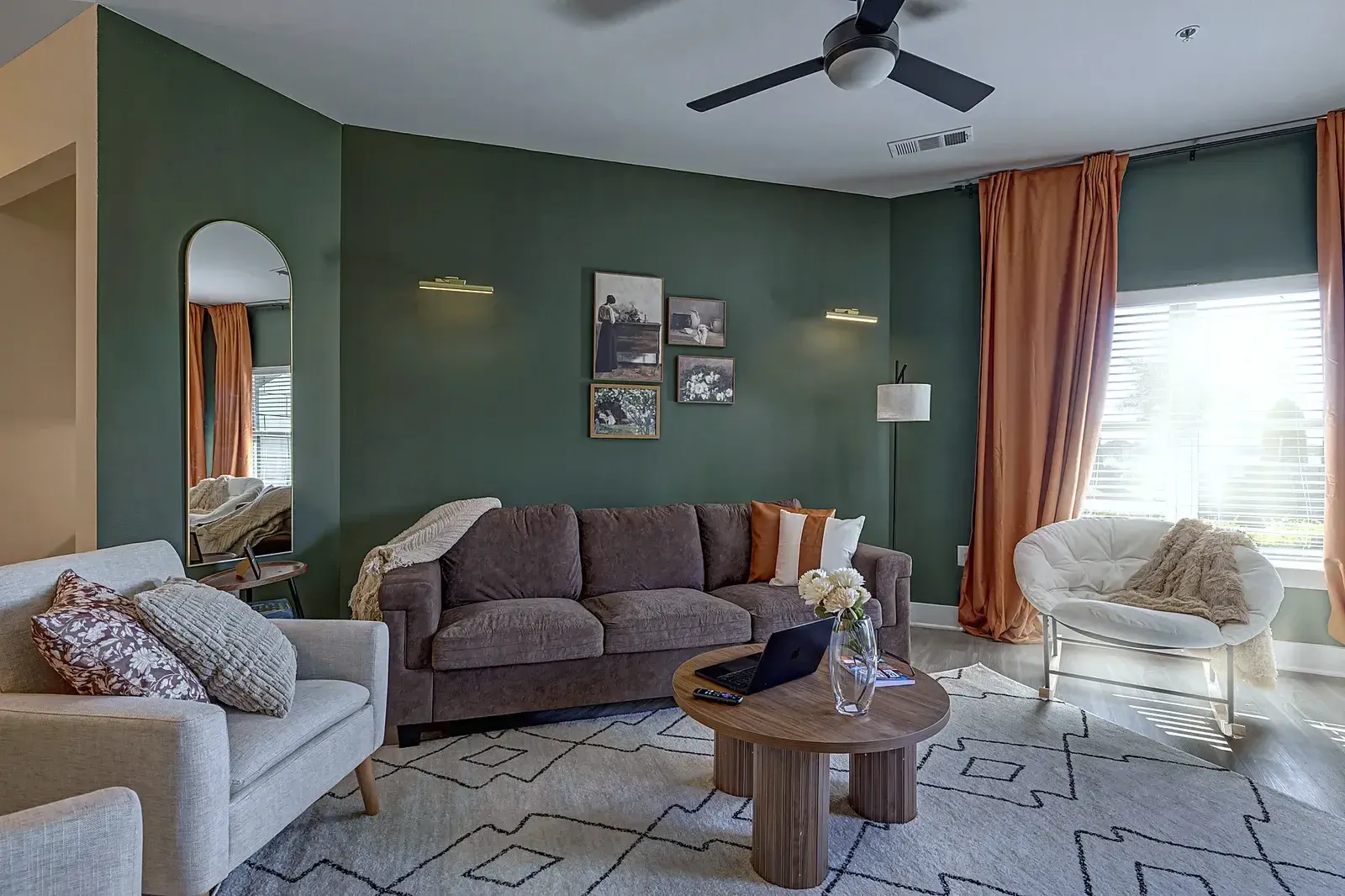Living room with sectional and arched mirror